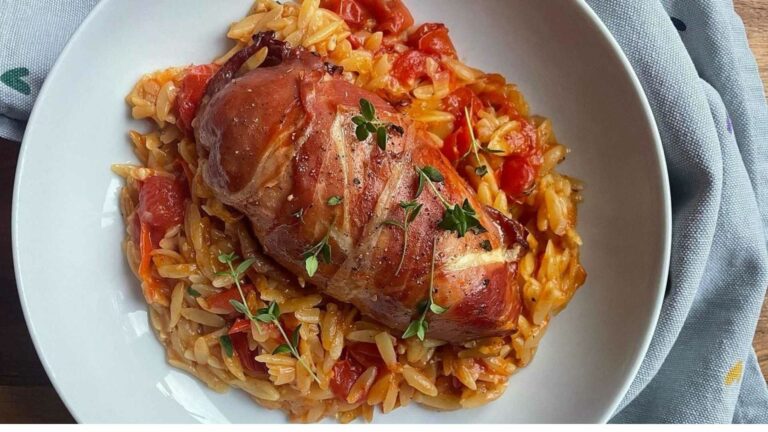 Chicken wrapped in prosciutto ham with tomato orzo