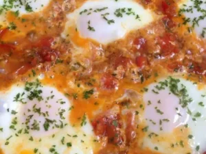 This easy-to-make recipe combines perfectly poached eggs with a rich tomato sauce, infused with aromatic spices.