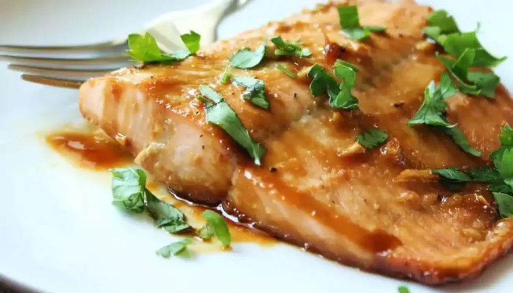 This dish features succulent salmon fillets coated with a delectable maple syrup glaze, creating the perfect balance of sweet and savory.