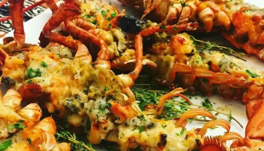 Indulge in the exquisite flavors of Lobster Thermidor, a classic French dish featuring succulent lobster bathed in a creamy, savory sauce and topped with a gratifying layer of cheese.