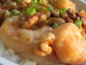 Sweet and Crunchy Walnut Shrimp is a delightful dish that combines succulent shrimp with a crispy coating of crushed walnuts. The shrimp are first coated in a light batter and then generously rolled in crushed walnuts before being fried to a golden perfection.