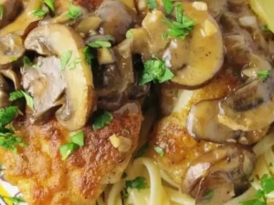 Savor tender, succulent chicken breasts coated in a golden crust, complemented by a rich and tangy sauce infused with an abundance of earthy mushrooms.