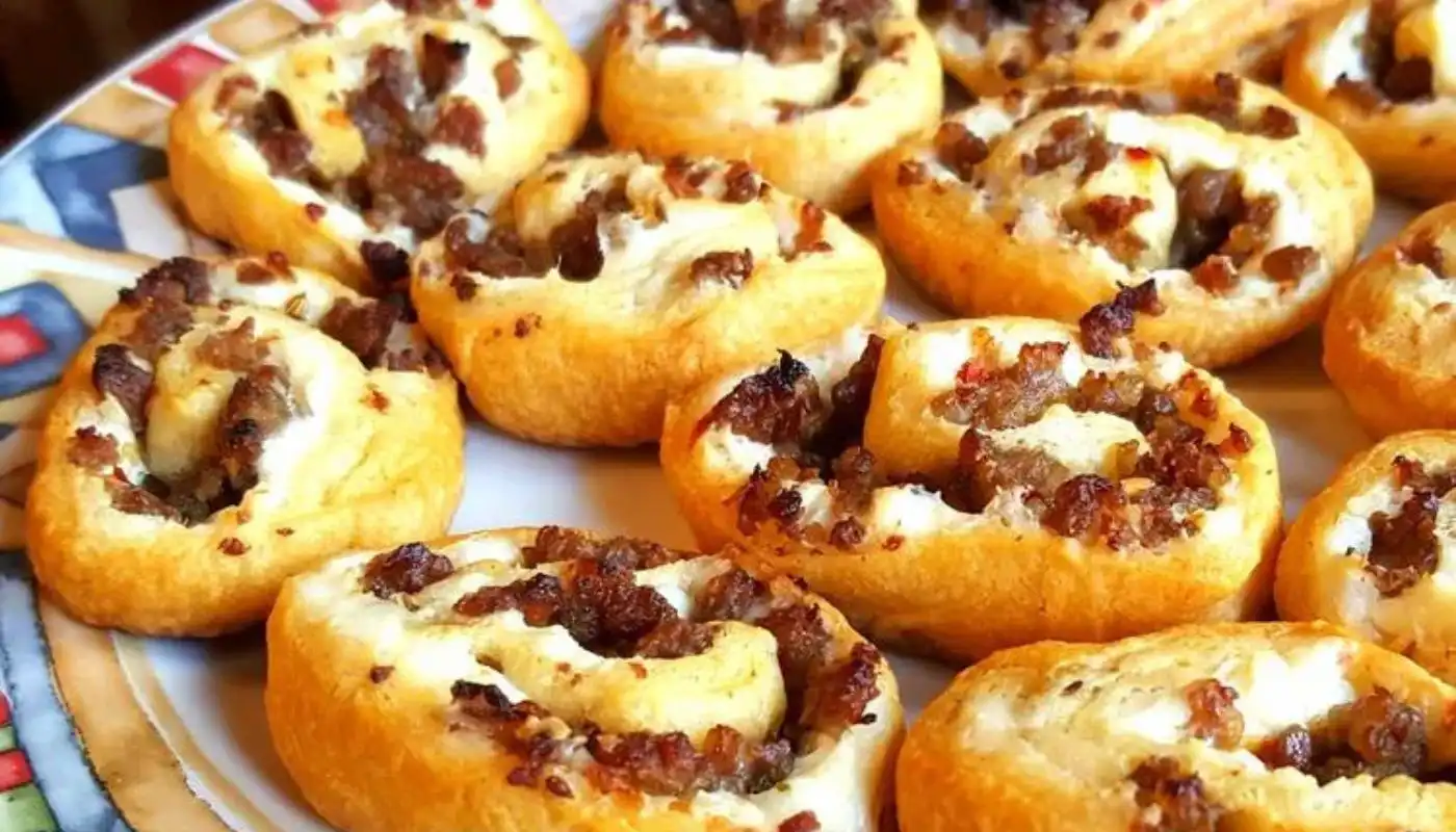 These delightful puff pastry treats feature a savory blend of sausage and cream cheese, rolled up into flaky perfection. Whether you're hosting a party or looking for a quick and delicious snack, these bite-sized pinwheels are sure to please.