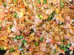 This mouthwatering dish combines tender chunks of ham with fluffy rice, crisp vegetables, and savory seasonings.