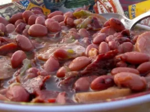 This classic Cajun dish features tender red kidney beans slow-cooked with aromatic spices, savory smoked sausage, and a medley of onions, bell peppers, and celery.