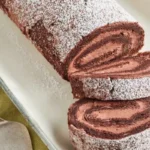 This irresistible dessert features a rich, velvety chocolate sponge cake rolled with a luscious cream filling, creating a stunning holiday centerpiece.