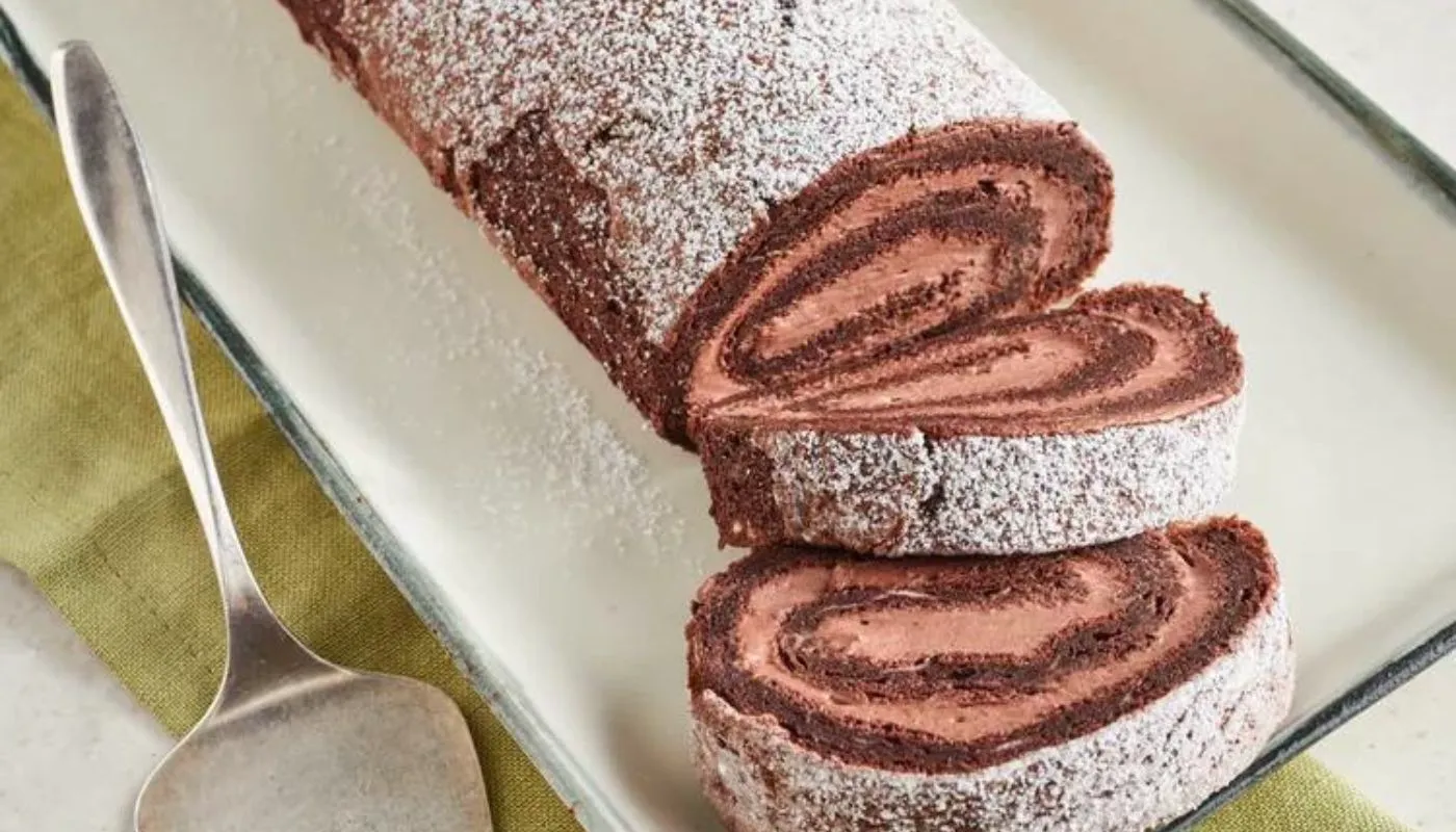 This irresistible dessert features a rich, velvety chocolate sponge cake rolled with a luscious cream filling, creating a stunning holiday centerpiece.