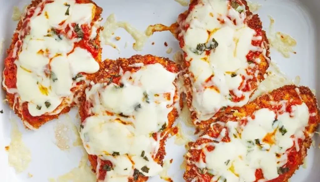 Tender chicken breasts are perfectly seasoned, coated in a savory blend of Parmesan cheese and Italian herbs, then baked to crispy perfection.