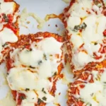 Tender chicken breasts are perfectly seasoned, coated in a savory blend of Parmesan cheese and Italian herbs, then baked to crispy perfection.