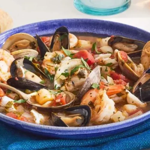 This savory seafood stew combines the freshest catch of the day with a tantalizing blend of tomatoes, herbs, and aromatic spices, creating a true coastal delight.