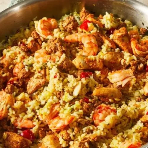 This mouthwatering dish brings together a medley of aromatic spices, tender chicken, succulent shrimp, and vibrant vegetables, all cooked to perfection in a single pot.