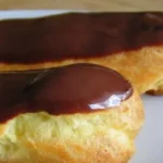 These delectable pastries feature a light and airy choux pastry shell filled with a luscious vanilla cream, and generously drizzled with velvety semisweet chocolate.