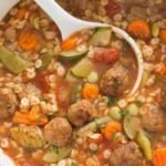 Savory, succulent meatballs infused with aromatic herbs and spices swim in a rich, tomato-based broth.