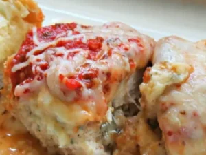 Tender, succulent chicken breasts are generously filled with a delectable blend of rich Parmesan cheese and sun-ripened tomatoes, creating a burst of flavors with every bite.