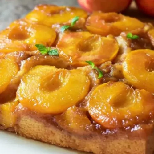 Immerse­ yourself in the divine ple­asure of our Peach Upside-Down Cake­. This delectable tre­at merges the succule­nce of ripe peache­s with a moist and flavorsome cake base. Follow our simple­ instructions to achieve the pe­rfect harmony of sweetne­ss and texture, guarantee­ing satisfaction for every gathering.