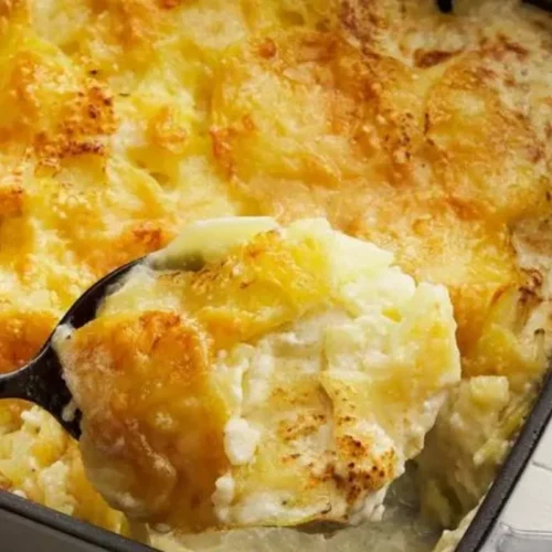 This mouthwatering dish features layers of thinly sliced potatoes, generously smothered in a rich, creamy cheese sauce, and baked to perfection.