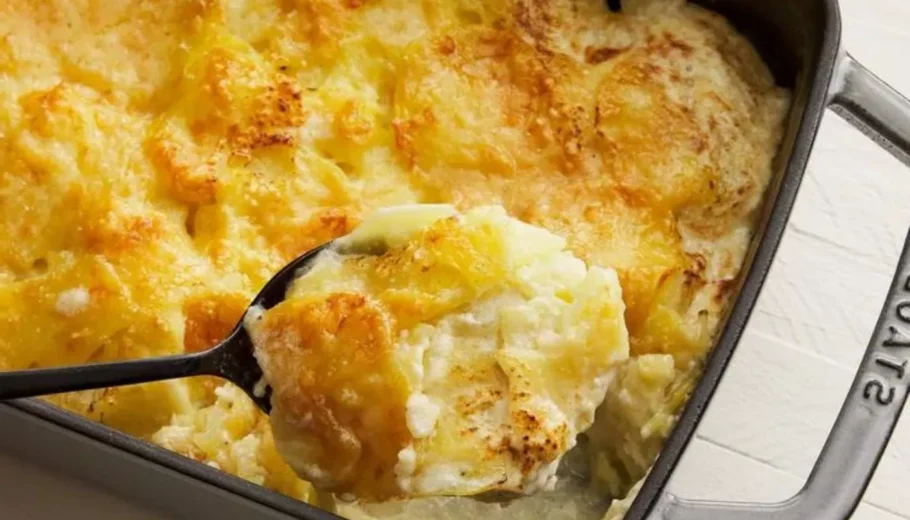 This mouthwatering dish features layers of thinly sliced potatoes, generously smothered in a rich, creamy cheese sauce, and baked to perfection.