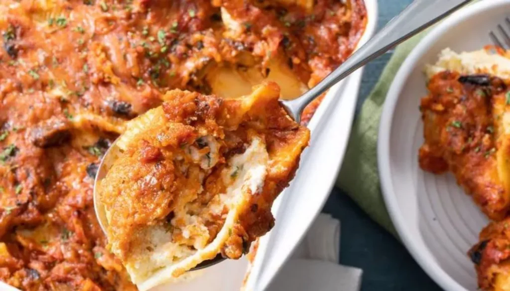These delectable pasta shells are generously filled with a creamy blend of ricotta, mozzarella, and parmesan cheeses, then baked to golden perfection.