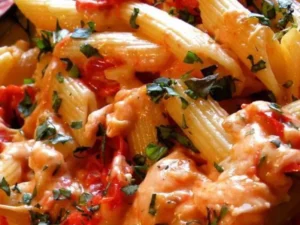 This mouthwatering recipe features al dente penne pasta smothered in a rich tomato and basil sauce, topped with a generous sprinkle of melted, gooey Parmesan cheese.