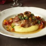 This Italian classic features tender, braised veal shanks, slow-cooked to perfection in a rich tomato and wine-based sauce, infused with aromatic herbs and vegetables.