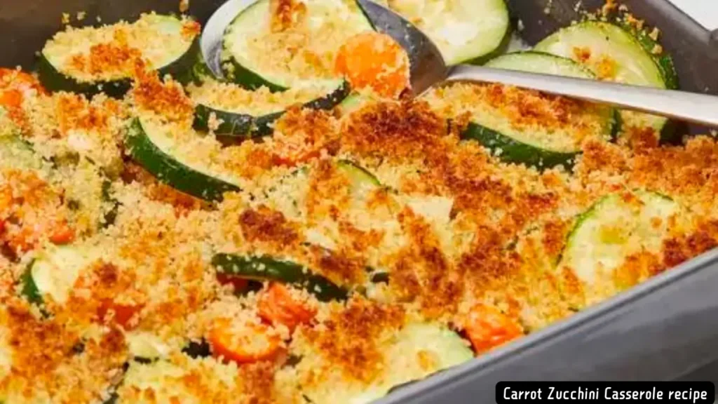 A close-up of a carrot zucchini casserole ready to be baked, topped with cheese and breadcrumbs.