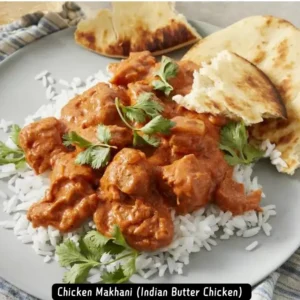 A plate of Chicken Makhani, also known as Indian Butter Chicken, served with basmati rice and naan bread
