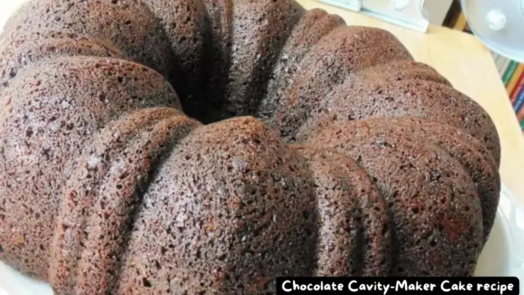 A perfectly baked Chocolate Cavity-Maker Cake displayed on a white plate, showcasing its rich and moist texture.