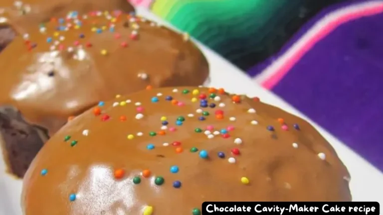 Close-up of Chocolate Cavity-Maker Cake topped with smooth caramel icing and colorful sprinkles