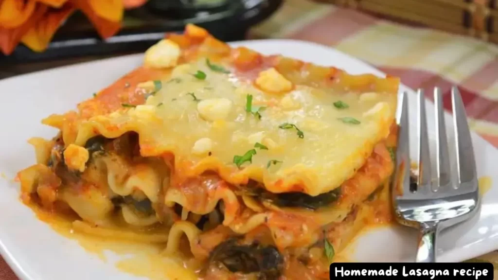 A serving of homemade lasagna on a white plate with layers of pasta, cheese, and meat sauce