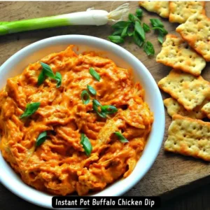 A bowl of creamy and spicy Instant Pot Buffalo Chicken Dip garnished with sliced green onions.