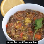 A bowl of Instant Pot Lentil Vegetable Soup with fresh vegetables.