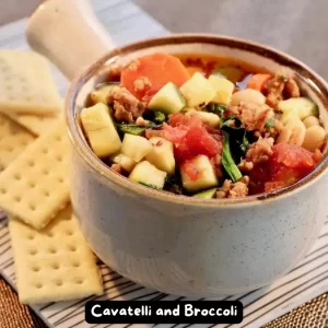 Bowl of hearty Italian sausage soup with carrots, zucchini, and spinach