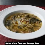 A bowl of Italian White Bean and Sausage Stew garnished with grated Parmigiano-Reggiano cheese and red pepper flakes.