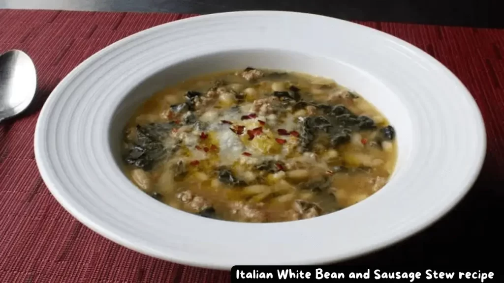 A bowl of Italian White Bean and Sausage Stew garnished with red pepper flakes and grated Parmigiano-Reggiano cheese.