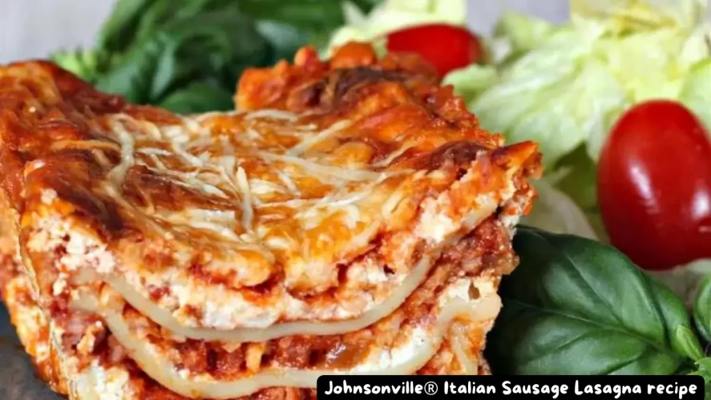 A close-up view of a slice of Johnsonville® Italian Sausage Lasagna, showcasing its layered noodles, meat sauce, and melted cheese, served with a fresh salad.