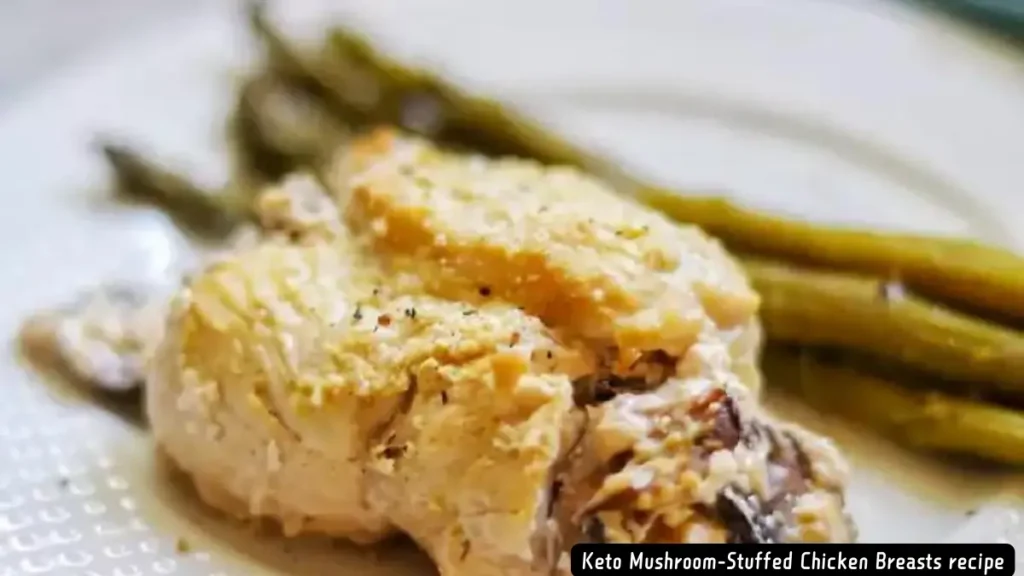 Keto Mushroom-Stuffed Chicken Breasts served with a side of asparagus on a white plate.