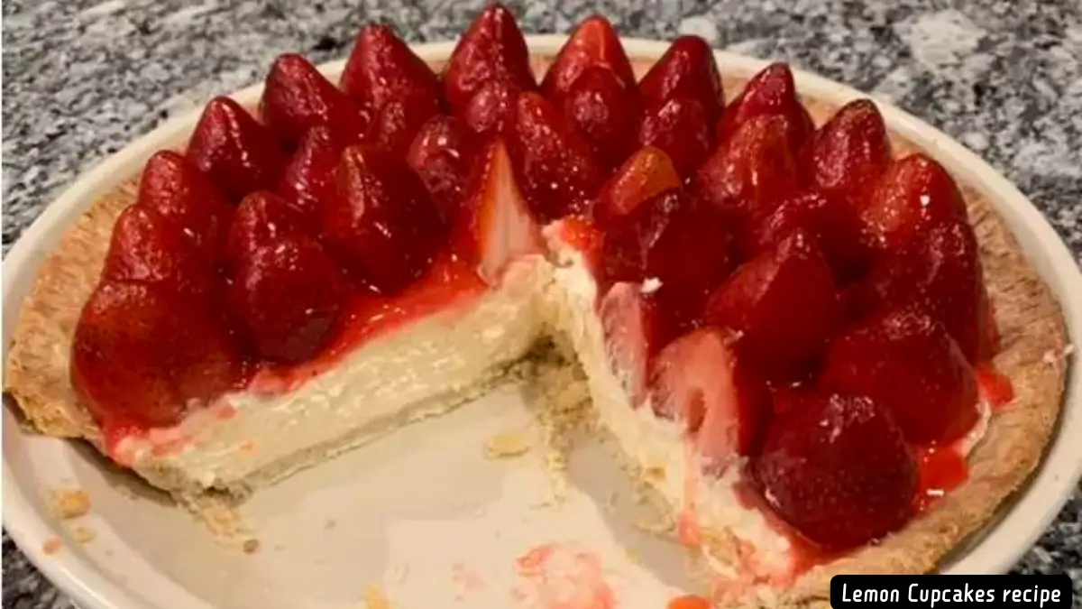 A delectable Two Tier Strawberry Pie with a creamy base and topped with fresh strawberries, showcasing a slice cut out to reveal the creamy layer inside.