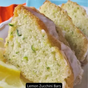 A tray of Lemon Zucchini Bars sprinkled with confectioners' sugar