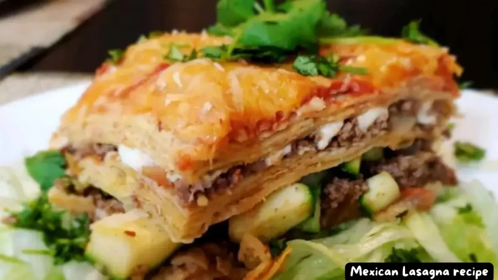 Close-up view of a delicious layered Mexican lasagna served on a plate with fresh vegetables.