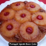 A deliciously caramelized Pineapple Upside-Down Cake topped with maraschino cherries.