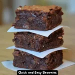 A close-up of freshly baked quick and easy brownies with a glossy, cracked top, sliced into squares.