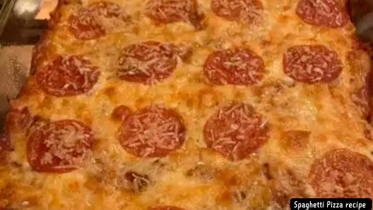 Close-up view of baked spaghetti pizza with melted cheese and pepperoni slices.