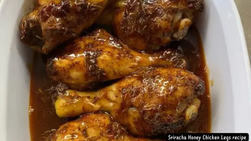 Golden-brown Sriracha Honey Chicken Legs in a white baking dish