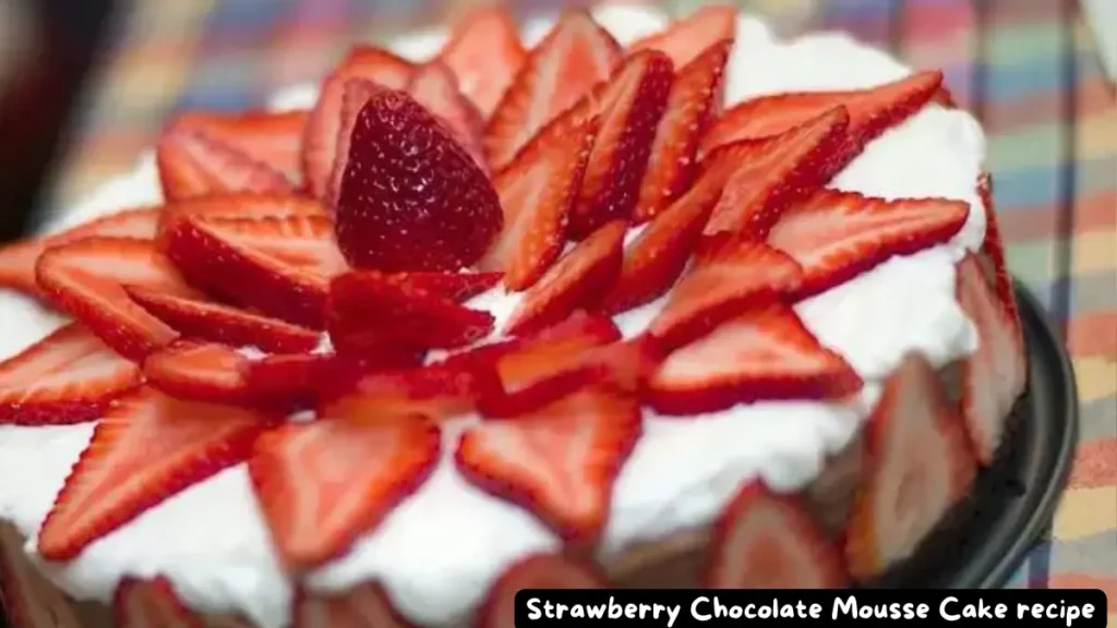 A delectable strawberry chocolate mousse cake topped with fresh strawberry slices arranged in a floral pattern.