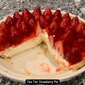 A mouth-watering Two Tier Strawberry Pie with fresh strawberries on top.