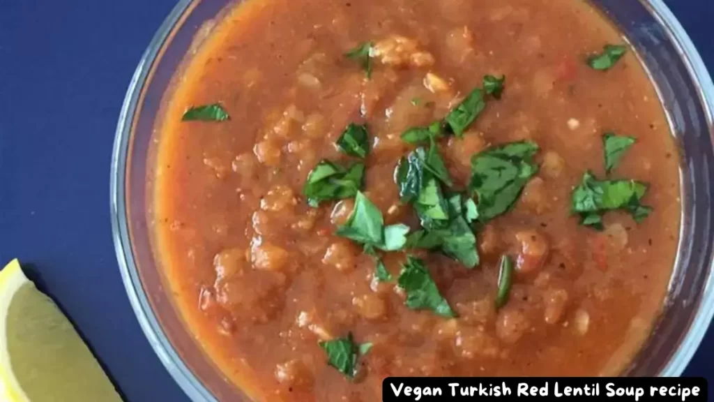 A close-up of Vegan Turkish Red Lentil Soup garnished with fresh parsley.