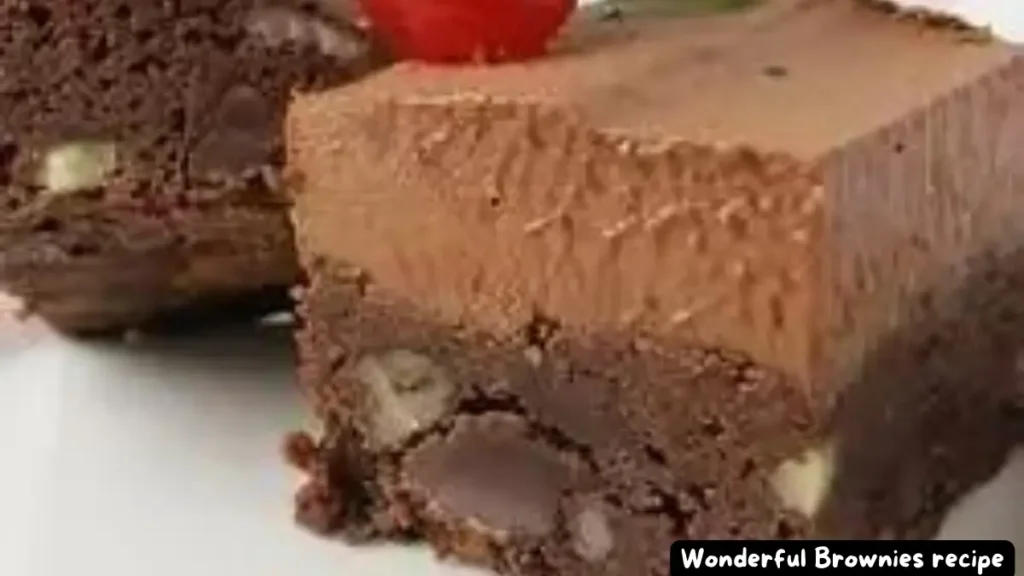 Easy and Delicious Wonderful Brownies topped with a cherry and mint leaf.