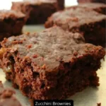 A tray of zucchini brownies topped with glossy chocolate frosting