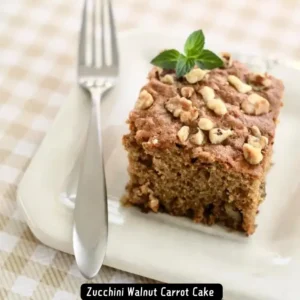 A slice of Zucchini Walnut Carrot Cake topped with walnuts