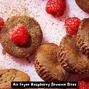 Air Fryer Raspberry Brownie Bites on a white plate with fresh raspberries